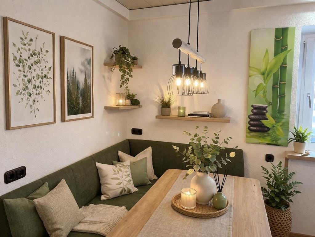 a living room with a green couch and a table at Charmantes Apartment Roding mit 3 Schlafzimmer in Roding