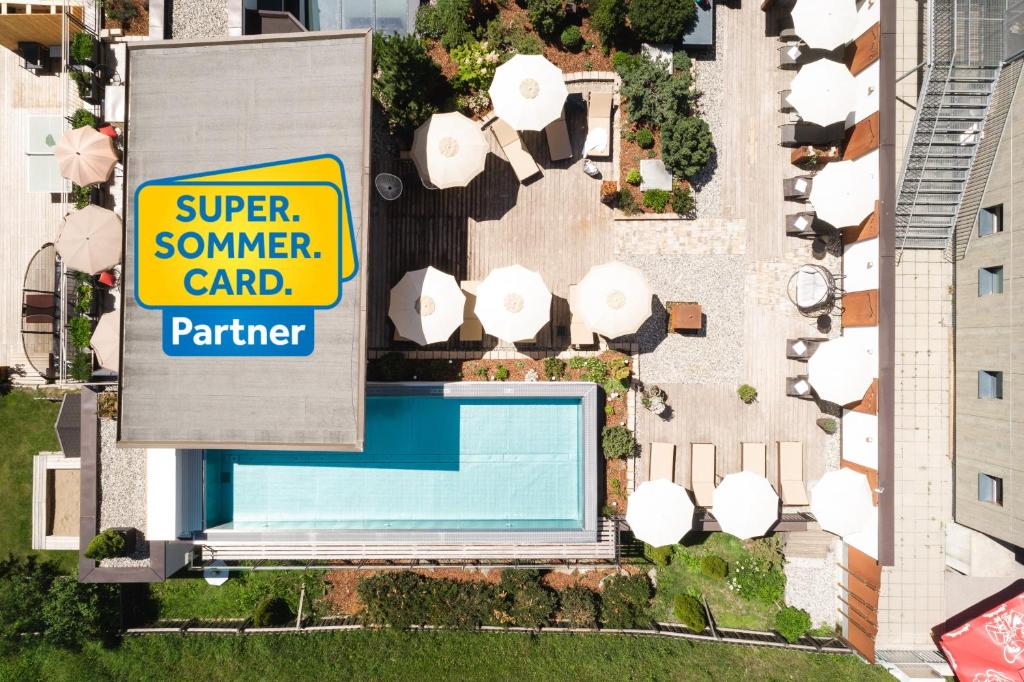 an overhead view of a swimming pool and a sign at Hotel Das Köhle - inklusive Super Sommer Card 2026 in Serfaus