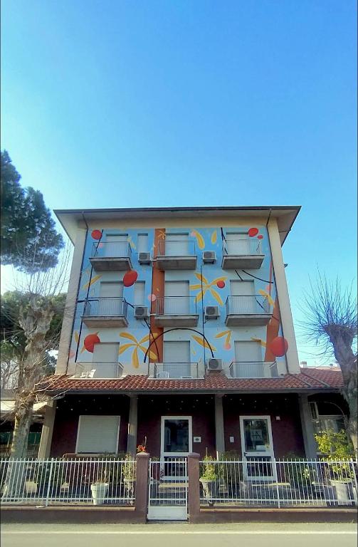 a building with a painting on the side of it at Fasthotel in Cervia