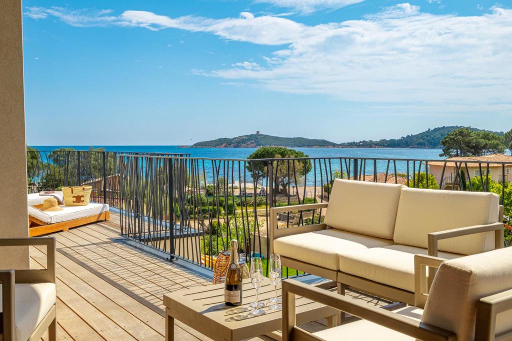 a balcony with a couch and a view of the water at CADIAMARE in Zonza
