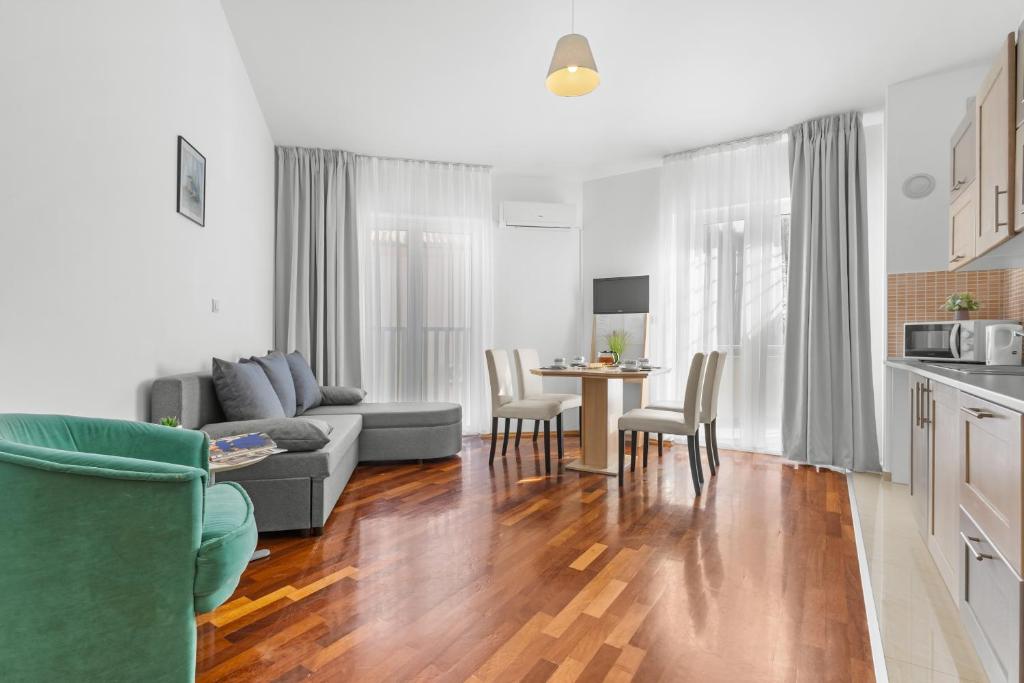 a living room with a couch and a table at LotusApart in Premantura