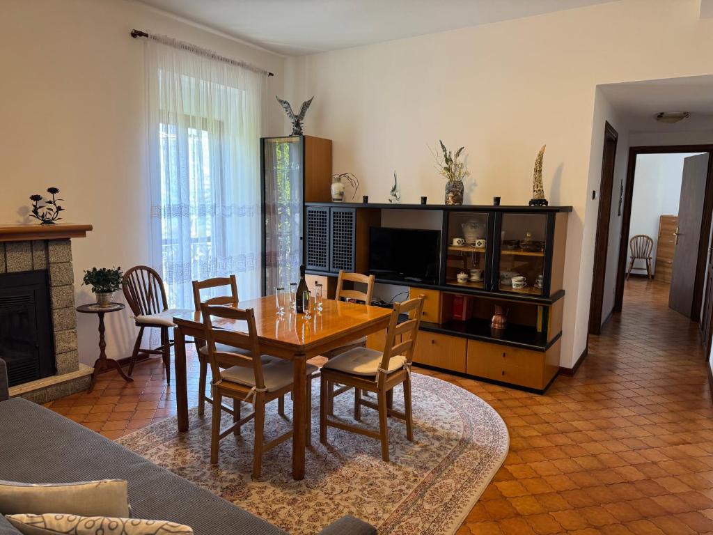 a dining room with a wooden table and chairs at Casa del pescatore e Mary! in Mezzegra