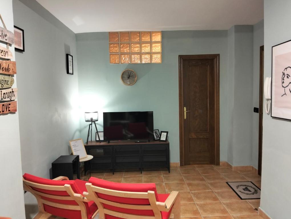 a living room with two chairs and a television at Modern Flat in Guejar Sierra in Güéjar-Sierra