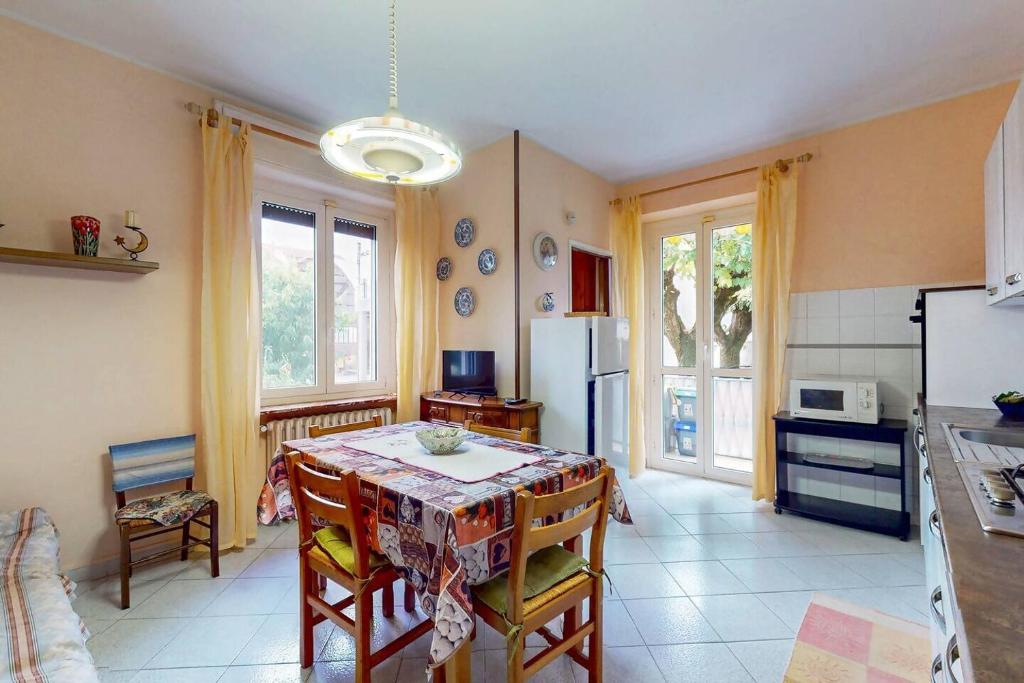 a kitchen with a table and a refrigerator at [Soleado] Il primo caffè con il sole da 3 lati in Acqui Terme