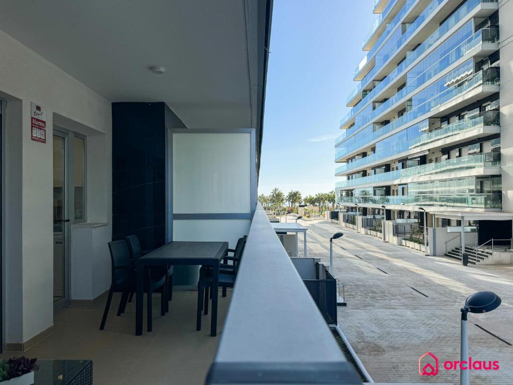 a balcony with a table and chairs and a building at El Privilegio in Cabanes