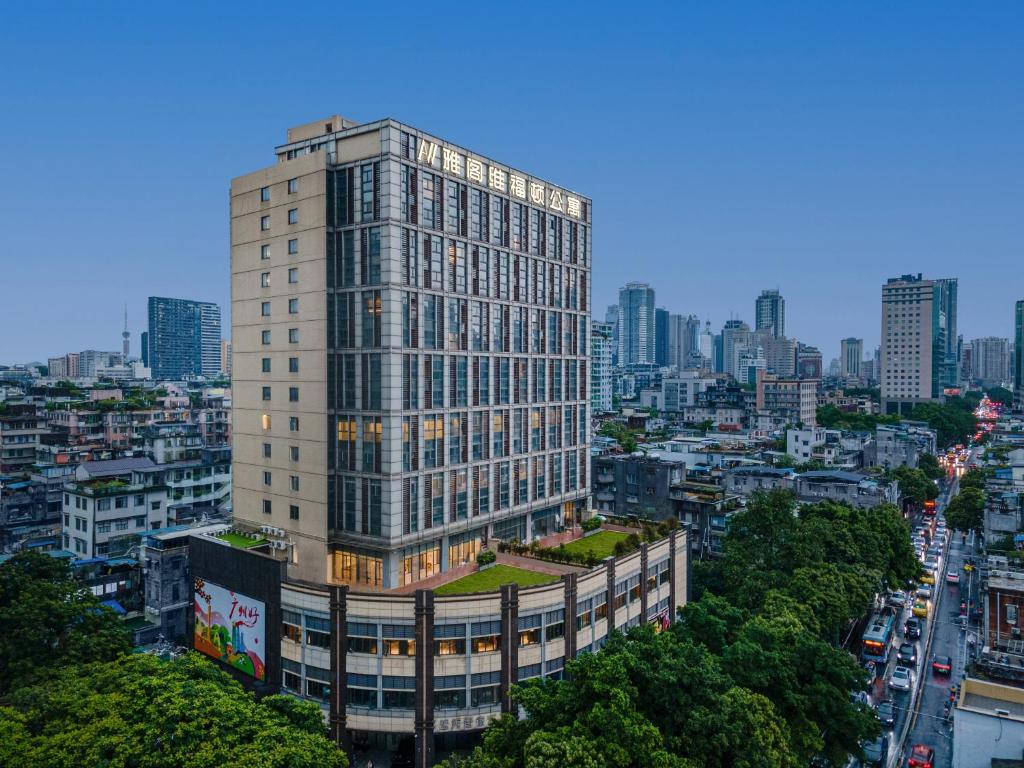 a tall building in the middle of a city at Argyle Waifiden Hotel in Guangzhou