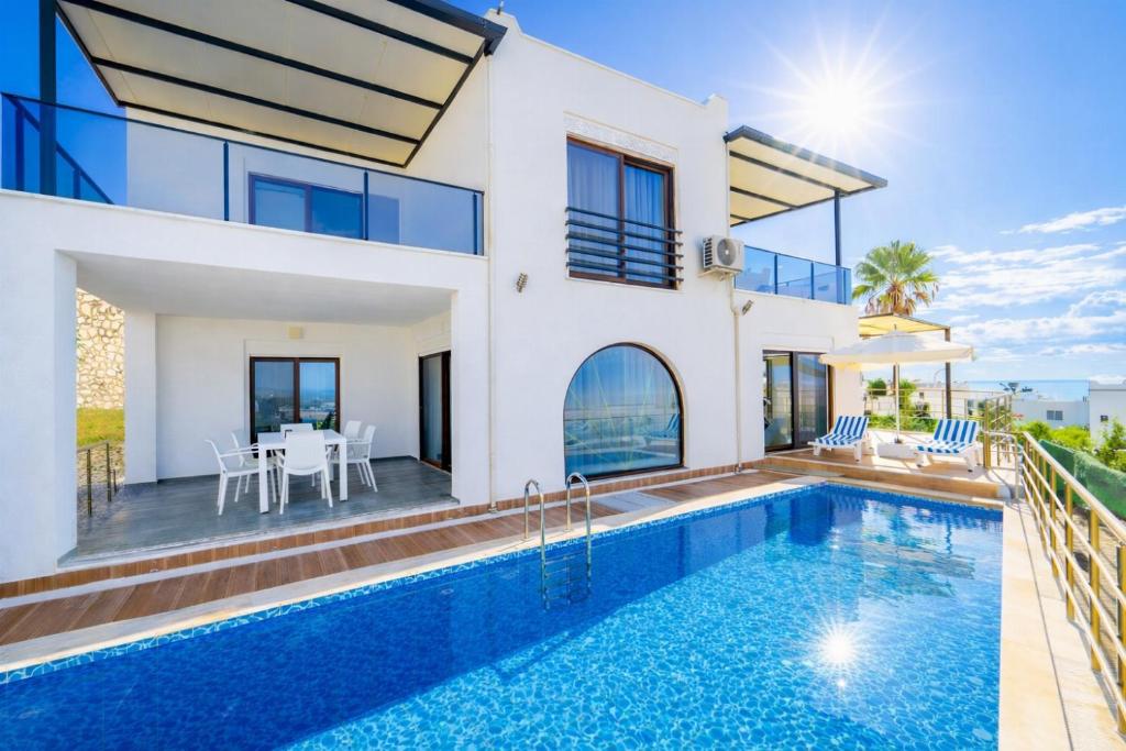 a villa with a swimming pool and a house at Villa Everest in Dalaman
