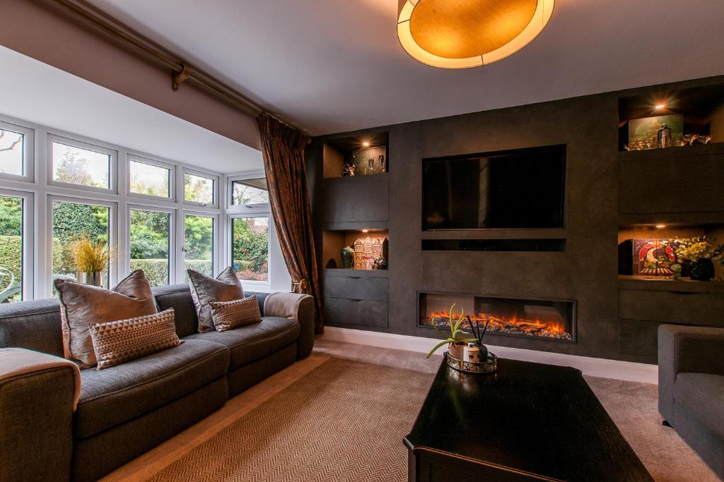 a living room with a couch and a fireplace at Luxury Beach Escape Pool Table & Private Parking in Broadstairs