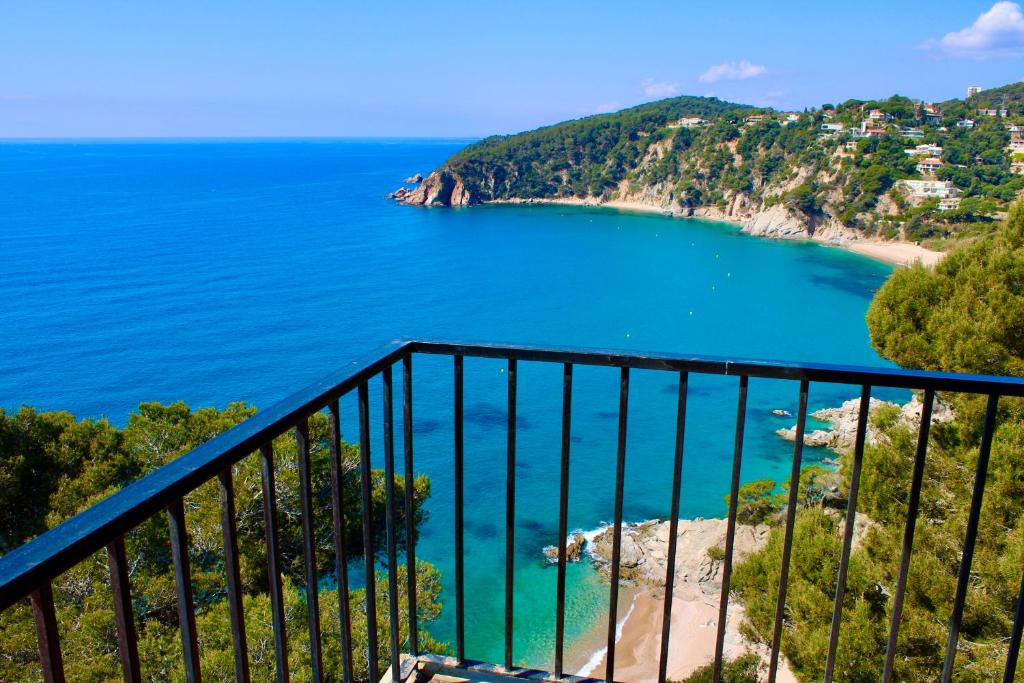 a view of a beach and the ocean at Apartamentos Cala Llevado in Tossa de Mar