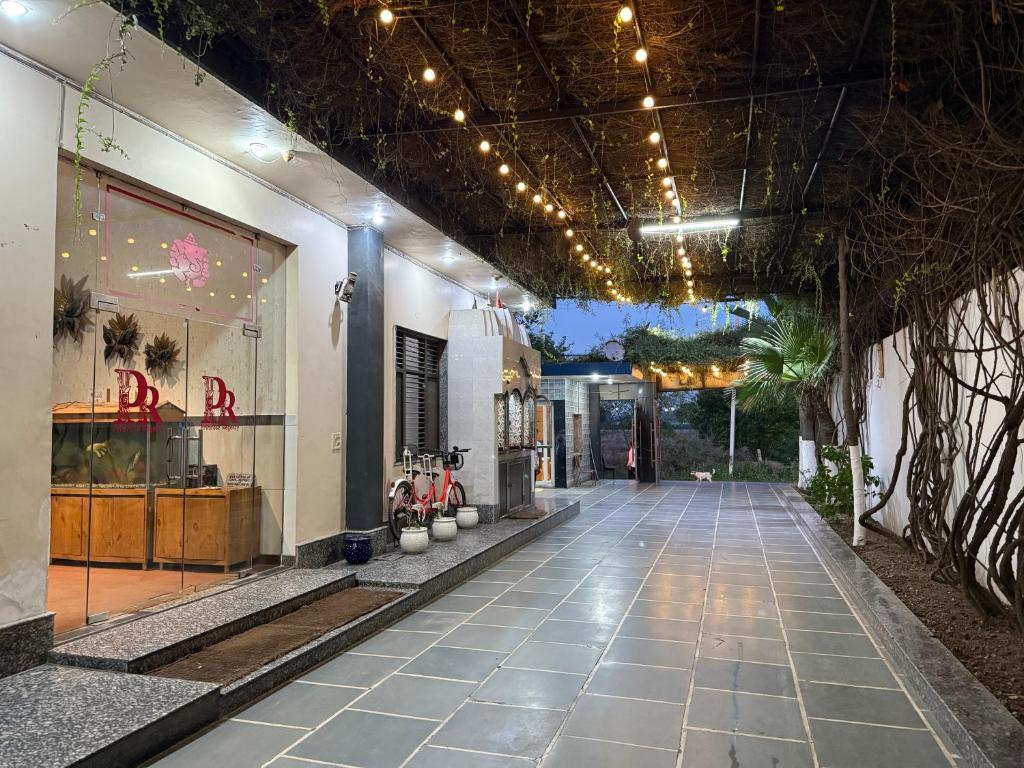 a hallway of a building with lights on the ceiling at Primrose Hotel in Murthal