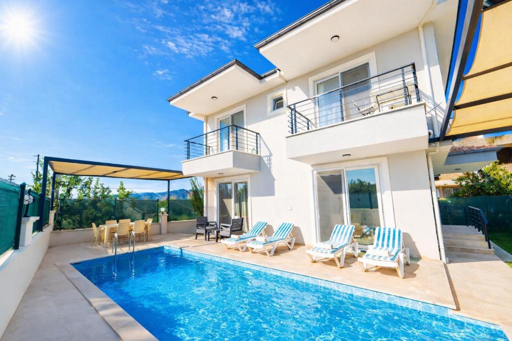 a villa with a swimming pool and a house at Villa Horizon in Ortaca