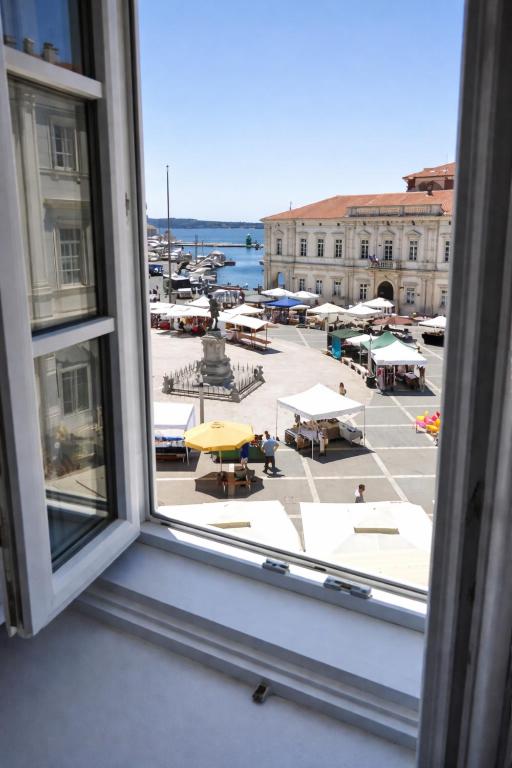 an open window with a view of a city street at Ellipse apartment in Piran