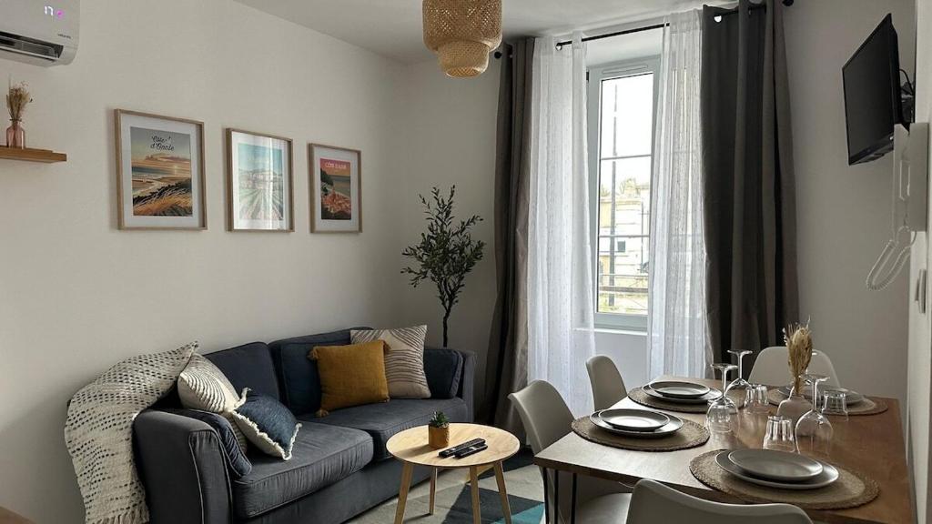 a living room with a blue couch and a table at la capeline in Chablis