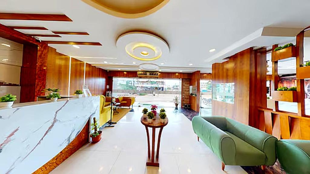a lobby with couches and a bar in a building at Hotel MEGA International Airport Zone in Hyderabad