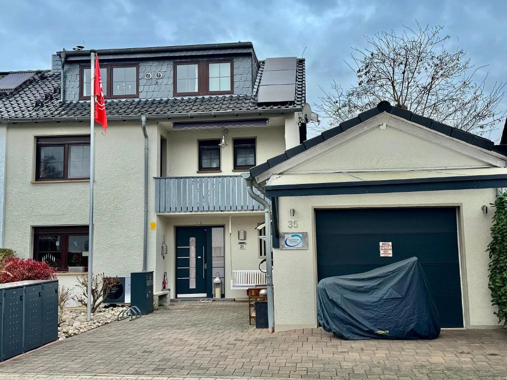 a house with a garage with a flag on it at Apartment to Düsseldorf - near Airport DUS - Trade Fair - Arena in Düsseldorf