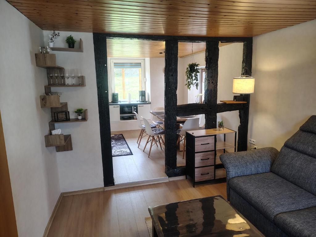 a living room with a couch and a table at Ferienhaus St Martin in Schalkenmehren
