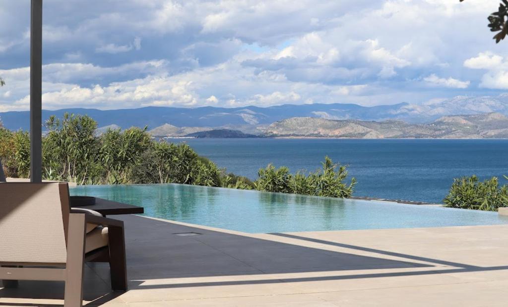 a swimming pool with a view of the water at Villa Thymari in Xiropigado