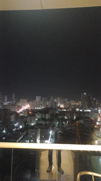 a view of a city at night from a building at Oasis TOWER 1105 in Ajman 