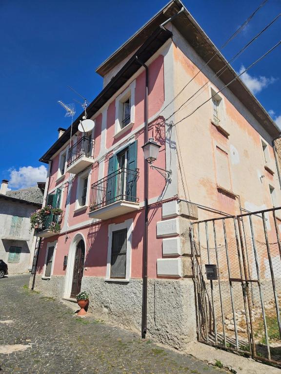 a pink building on the side of a street at Da Papone in Massa dʼAlbe