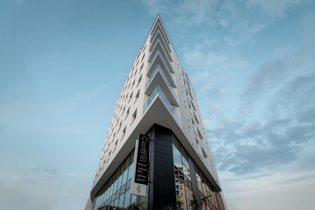 a tall building with a blue sky in the background at Central Hotel in Ferizaj