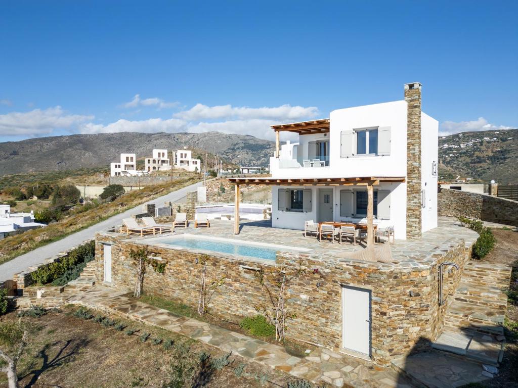 a villa with a swimming pool on a hill at West Side Pool House by Hostandros in Gavrio