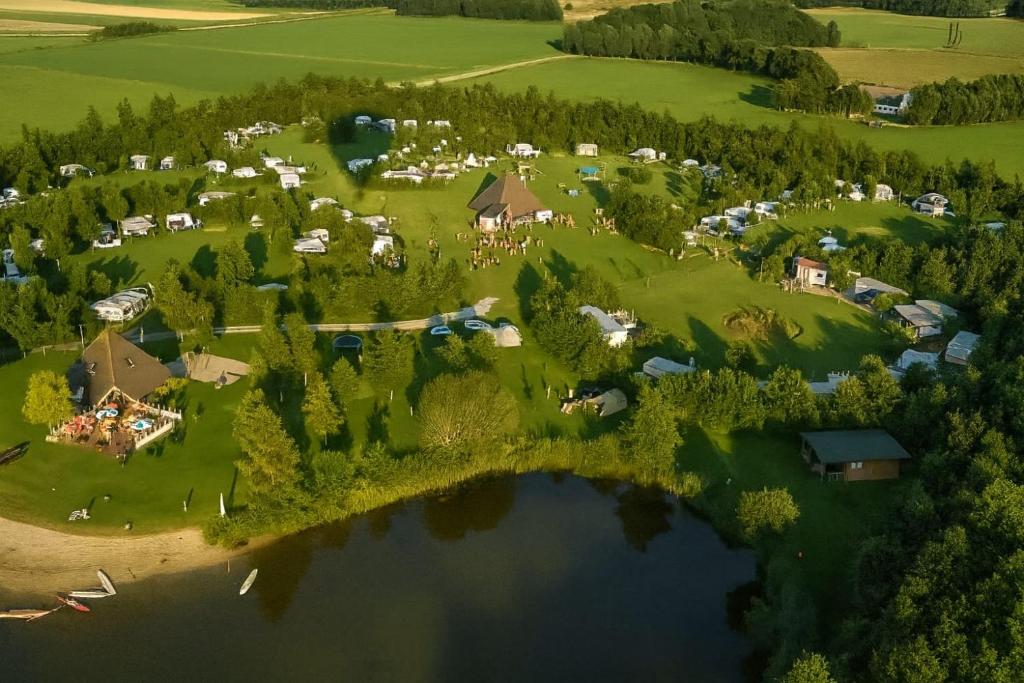 an aerial view of a resort with a lake at Camping Hunze Bulten in Annen