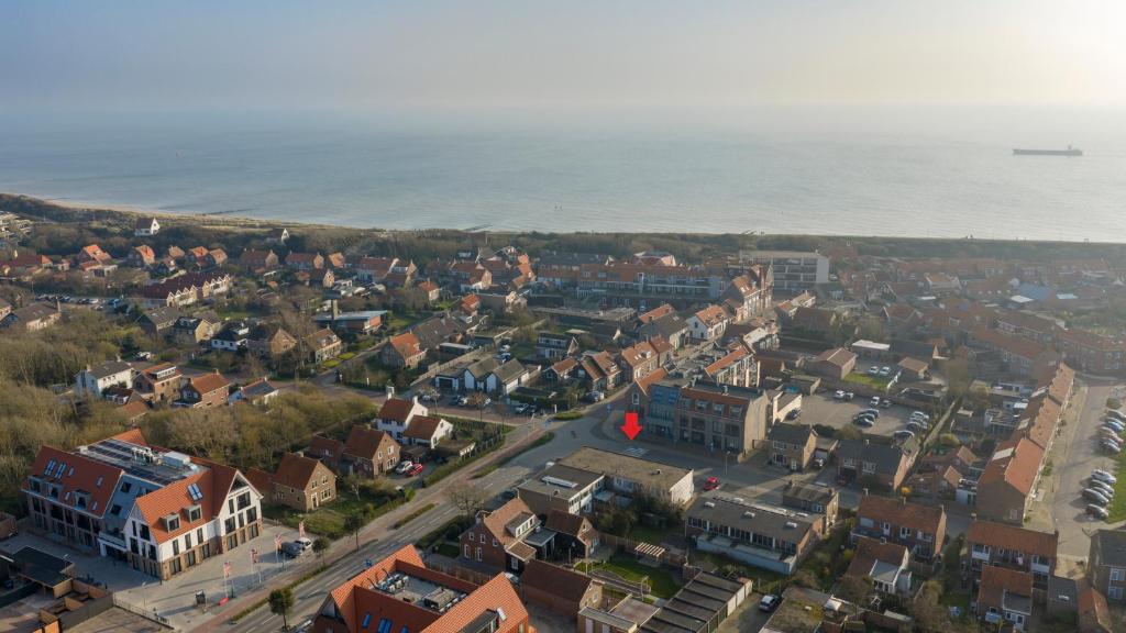 an aerial view of a town next to the ocean at Ooststraat 23 in Zoutelande
