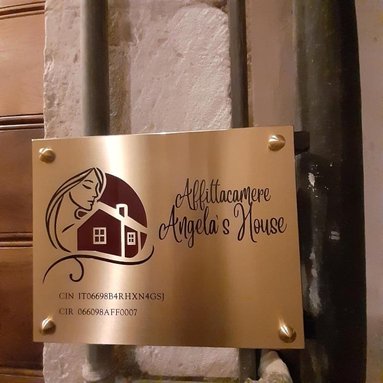 a sign on a wall with a house on it at Angela's house in Sulmona