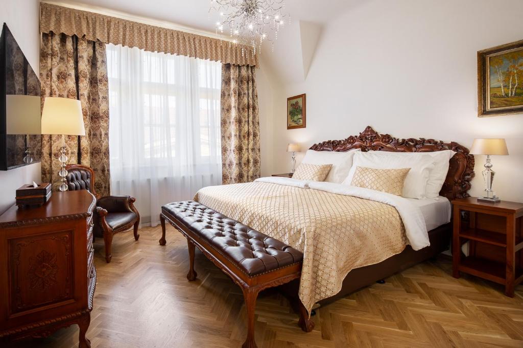 a bedroom with a large bed and a table at BHG Apartments Prague in Prague