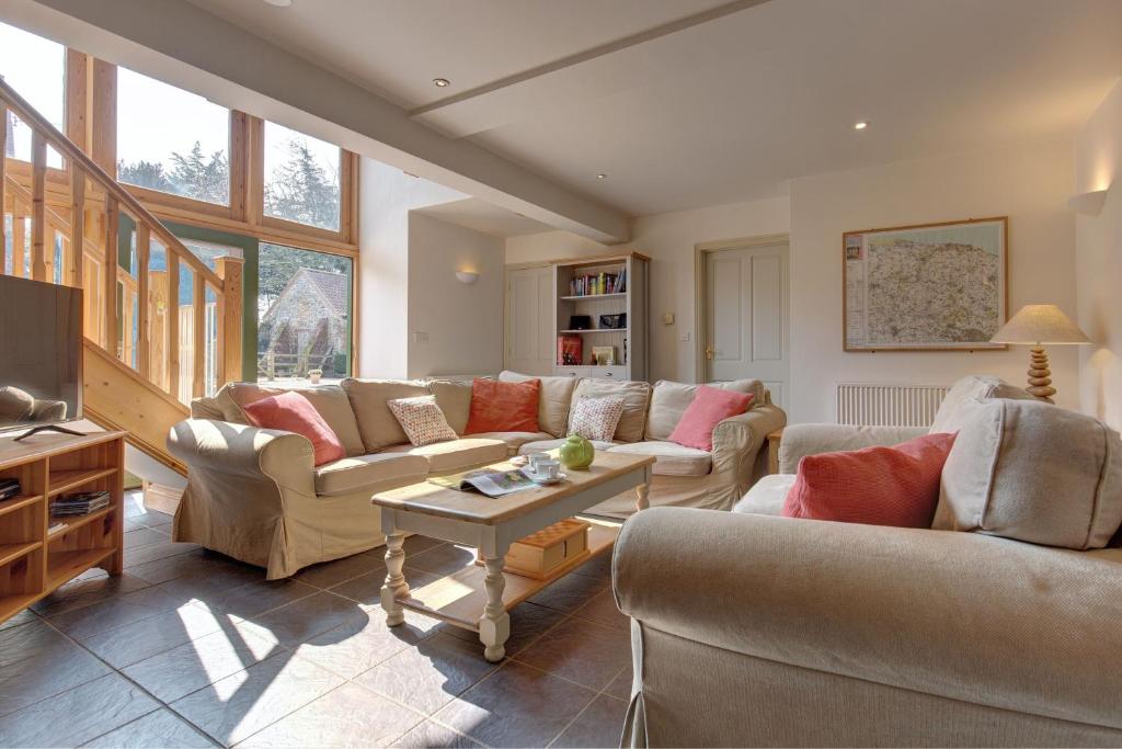 a large living room with couches and a table at Chaff House, Rookery Farm in West Beckham