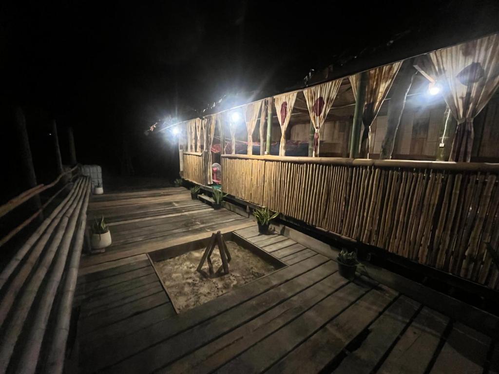 a train sitting on a wooden deck at night at Sleep tourism Maewang in Ban Huai Rin