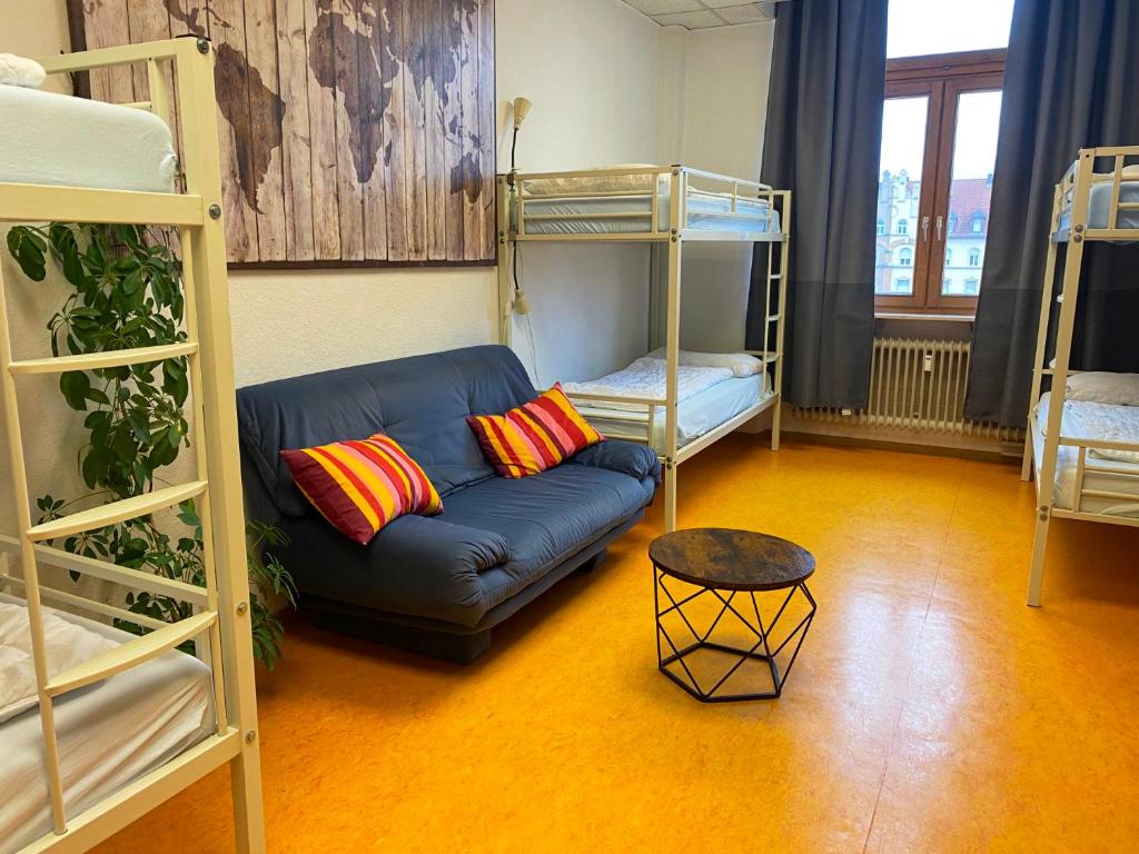 a living room with a couch and bunk beds at Steffis Hostel Heidelberg in Heidelberg