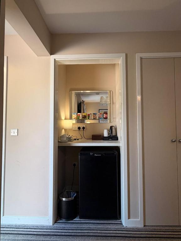 a kitchen with a sink and a mirror in a room at The Red Lion Bed and Breakfast in Kings Walden