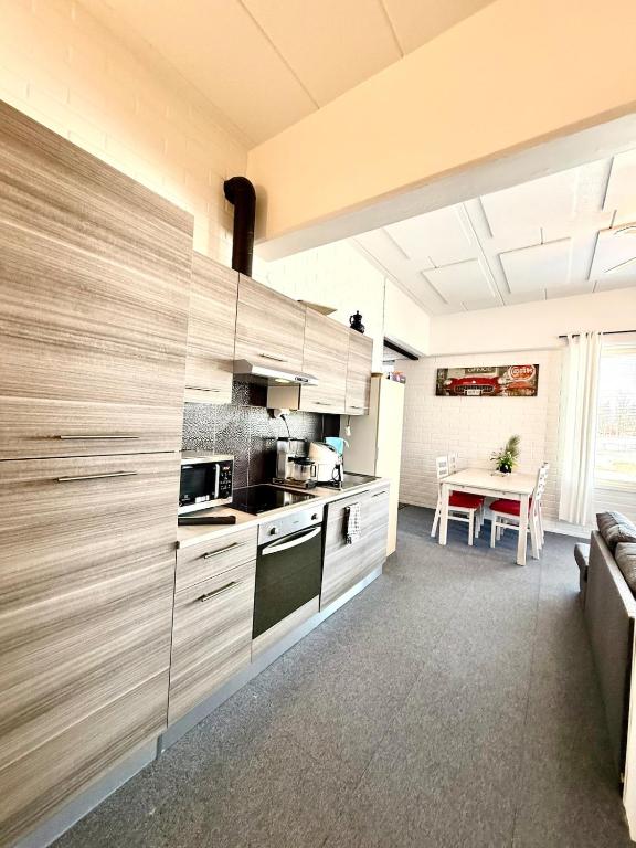 a kitchen with stainless steel cabinets and a table at Casa de Fit in Joensuu