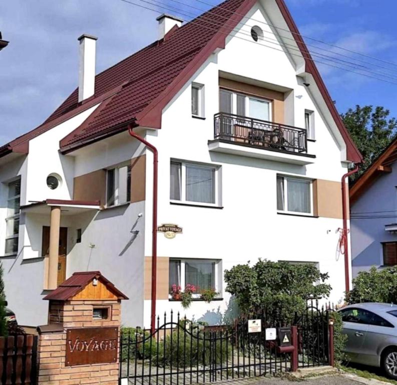 a white house with a brown roof at Privat Voyage with Pool in Liptovský Mikuláš