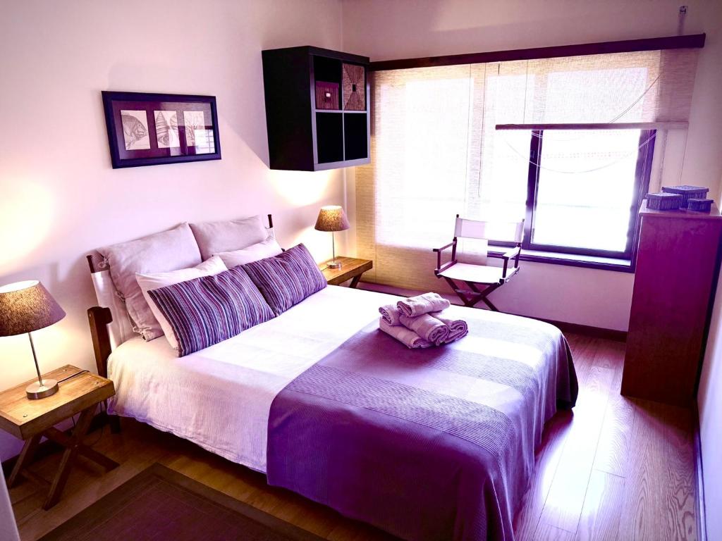 a bedroom with a bed with a stuffed animal on it at Garrett by the Sea in Vila do Conde