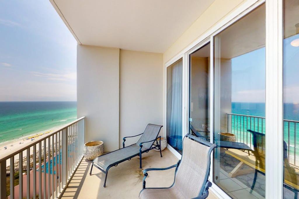 two chairs on a balcony with a view of the ocean at Gulf-Front Condo with Pools and Gym in Destin
