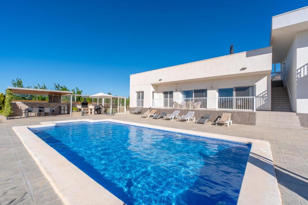 a swimming pool in front of a house at Macisvenda relax in Macisbenda