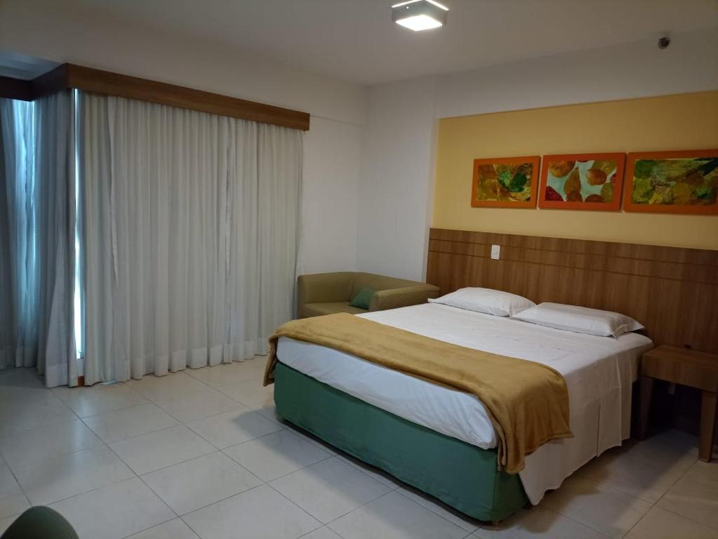 a bedroom with a large bed in a room at Flat Particular Marizienne Hotel Saint Moritz 86 in Brasília