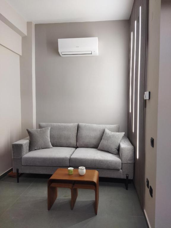 a living room with a couch and a table at The swanky studio in Anatolí