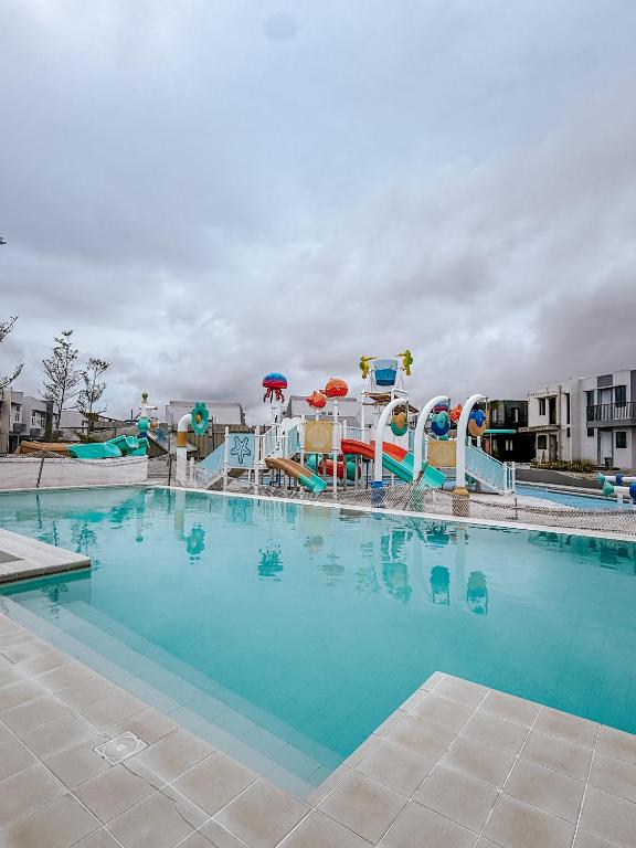a large swimming pool with a water park at Enzos Haven - Tagaytay in Tagaytay