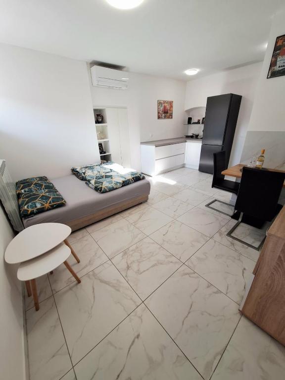 a living room with a bed and a table and chairs at Casa D'oro1700 - Old town Koper in Koper
