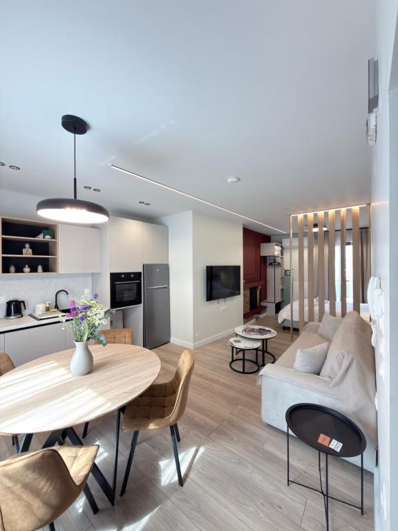 a living room with a table and a couch at By The River Stay in Florina
