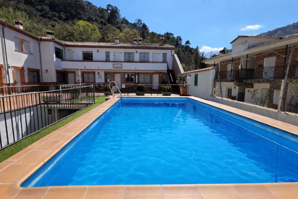 a swimming pool in front of a house at ESTRELLA del GUADALQUIVIR in Arroyo Frio