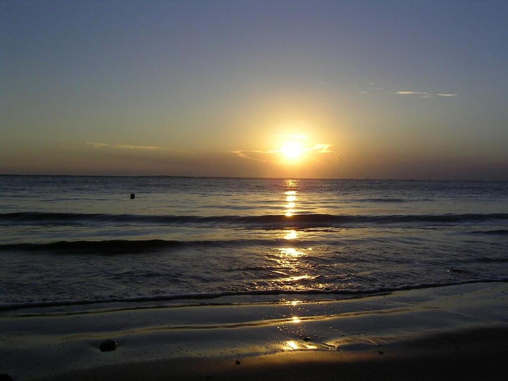 a sunset on a beach with the ocean at bubu in Kobuleti