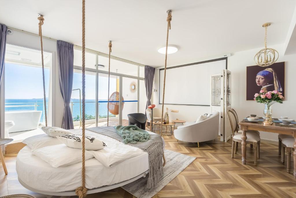 a bedroom with a swinging bed and a bathtub at Yumian Cloud Seaview Hotel in Sanya