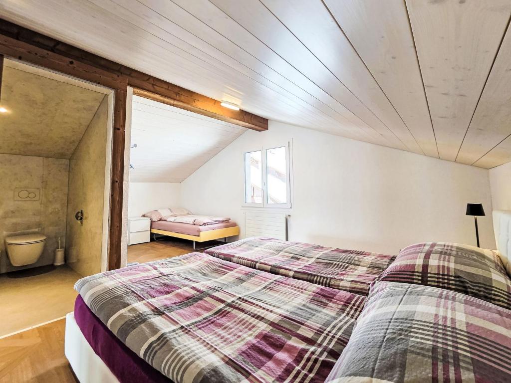 a bedroom with two beds and a window at Apartment LiloTopMountainView by Interhome in Beatenberg