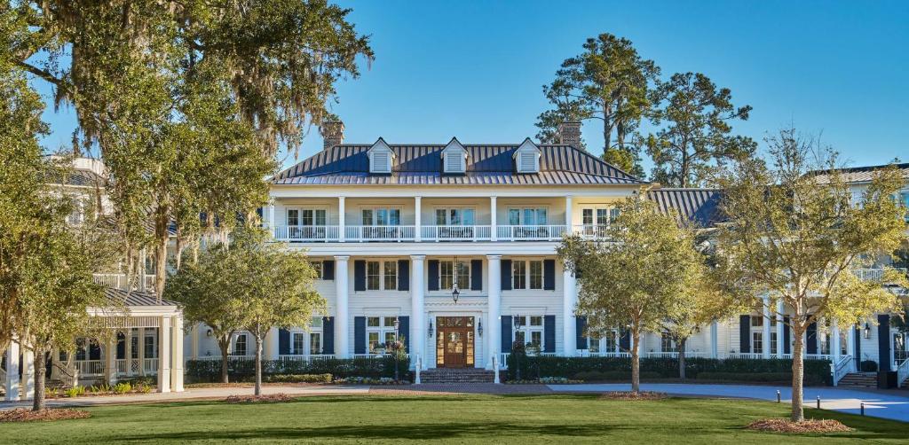 a large white house with trees in front of it at Montage Palmetto Bluff in Bluffton