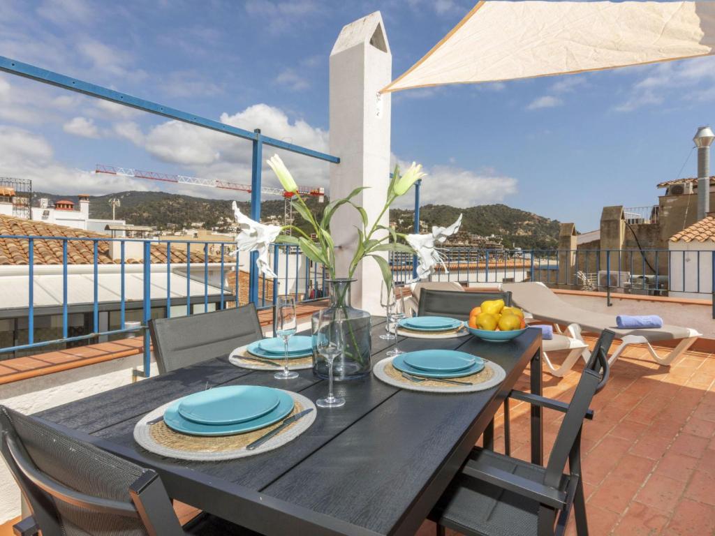 a dining table on a balcony with a view of the city at Apartment Mestral Atic by Interhome in Tossa de Mar
