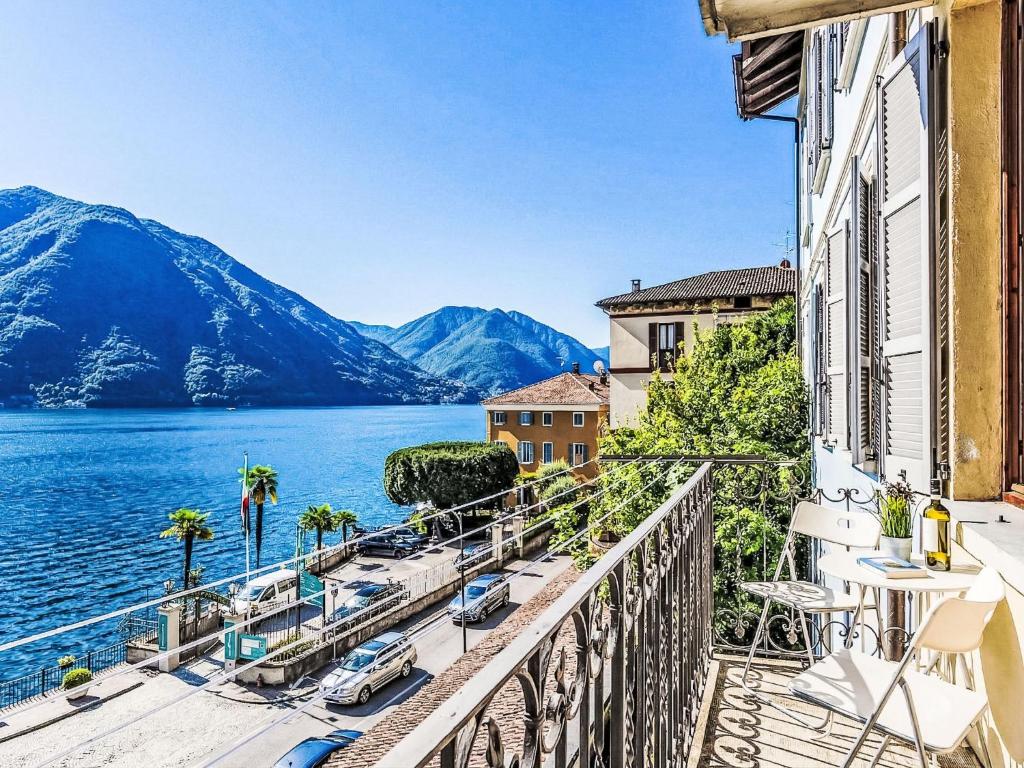 a balcony with a view of a lake and mountains at Apartment Martino by Interhome in Argegno